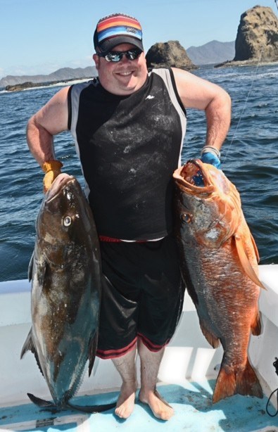 Chris with 2 fish he caught with Costa Rica Fishing Charters